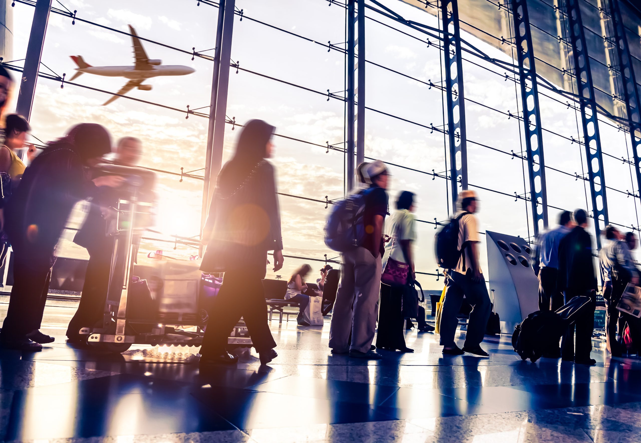Busy airport with figures in motion and an airplane taking off