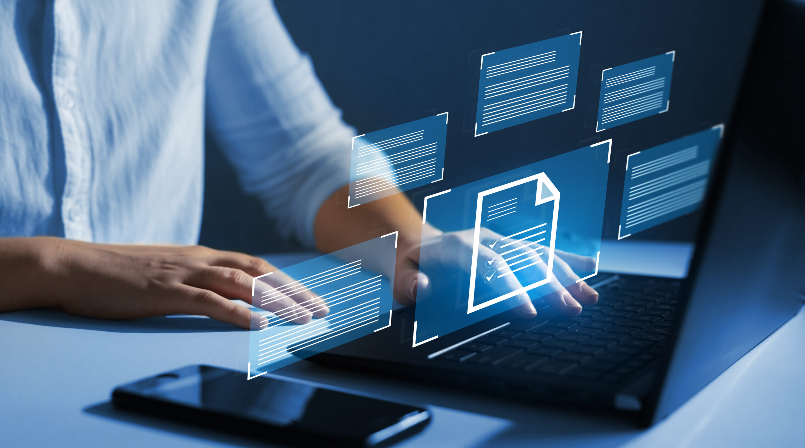 Hands over a keyboard with an overlay of futuristic screens